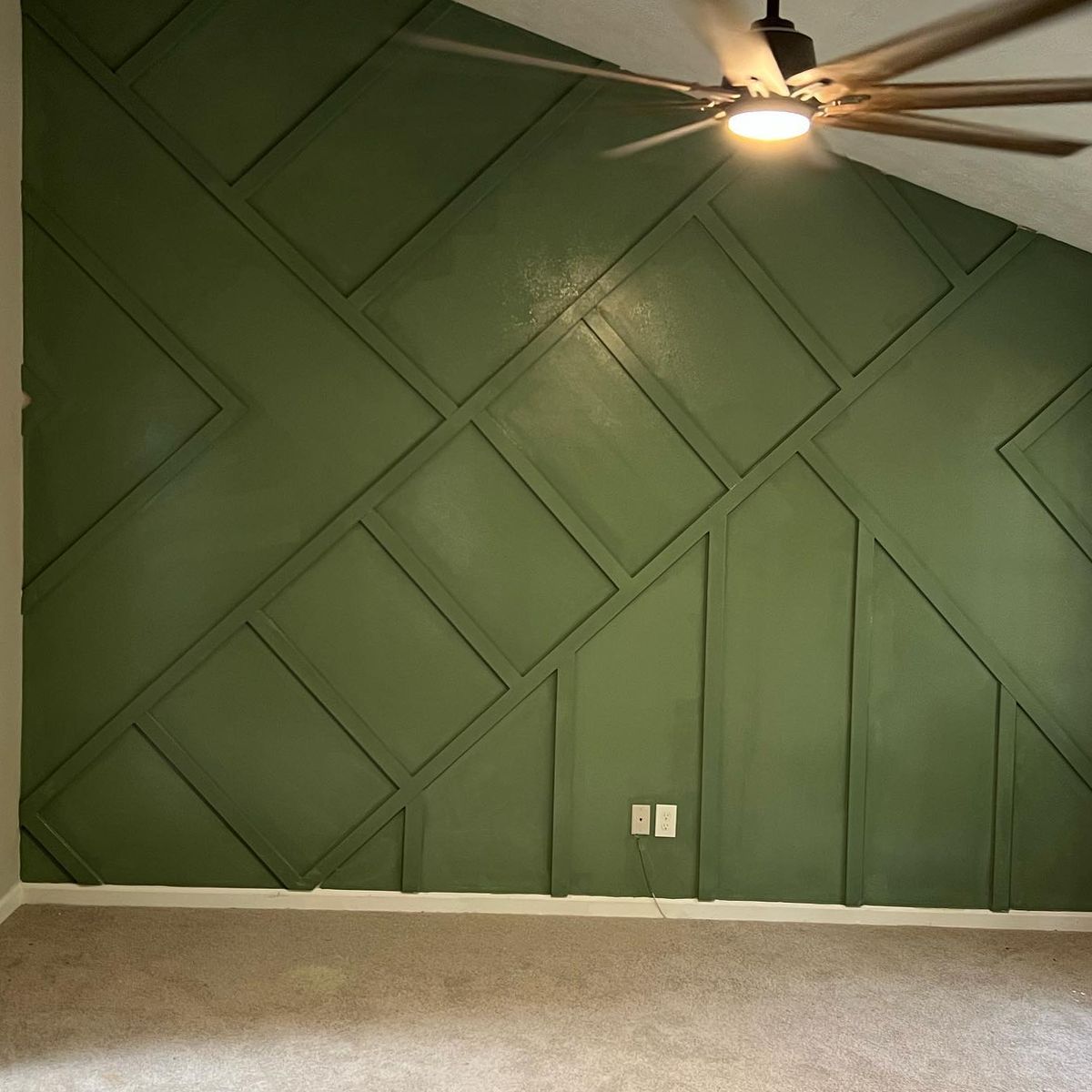 After: the same wall with the trim and wall painted green