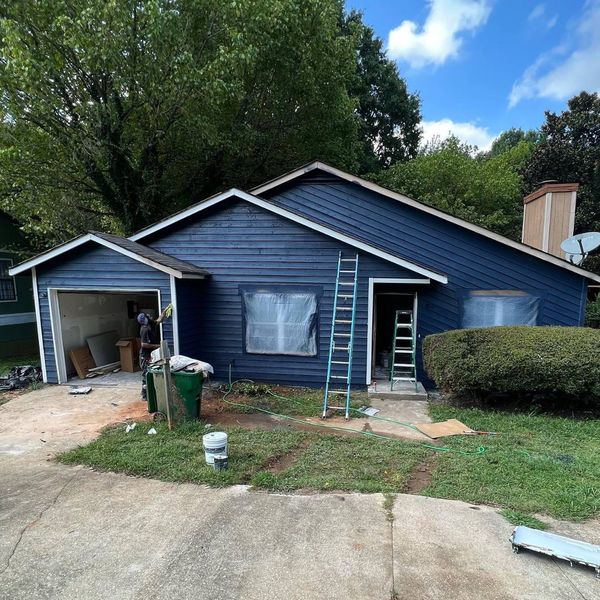 House exterior repainted navy with white trim